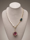 Freshwater pearl and gold chain necklace with raw pink and green stones on a display bust