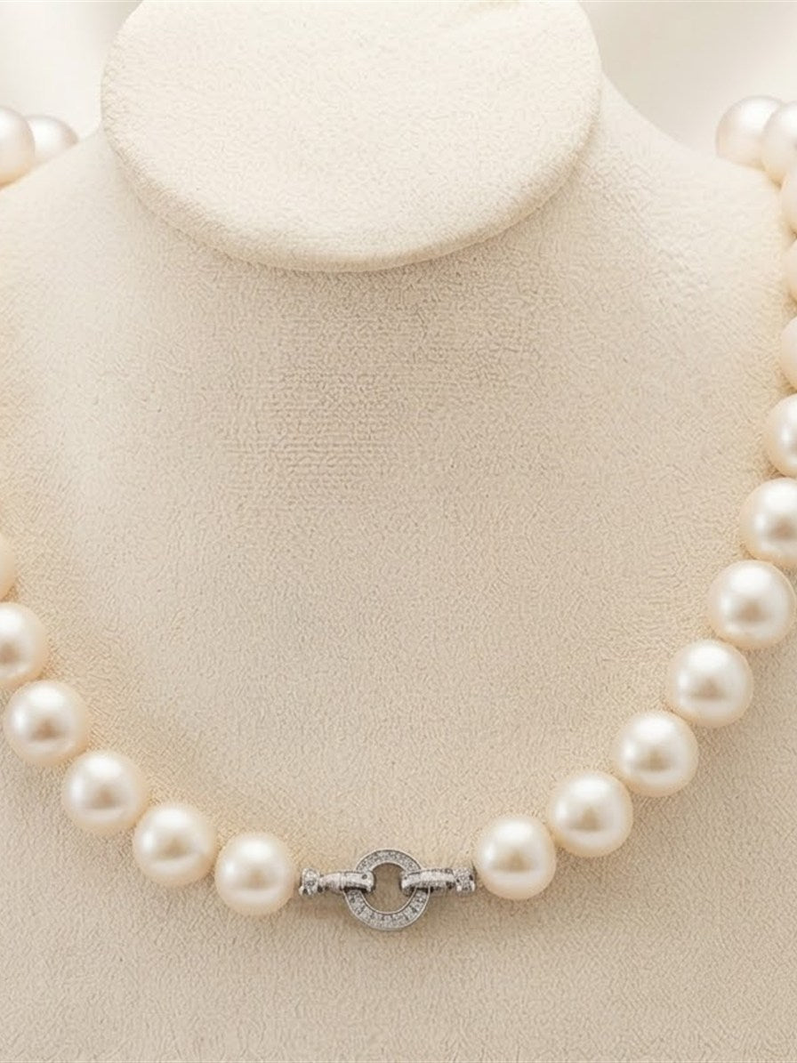 White freshwater pearl necklace on a display bust with the clasp at the front