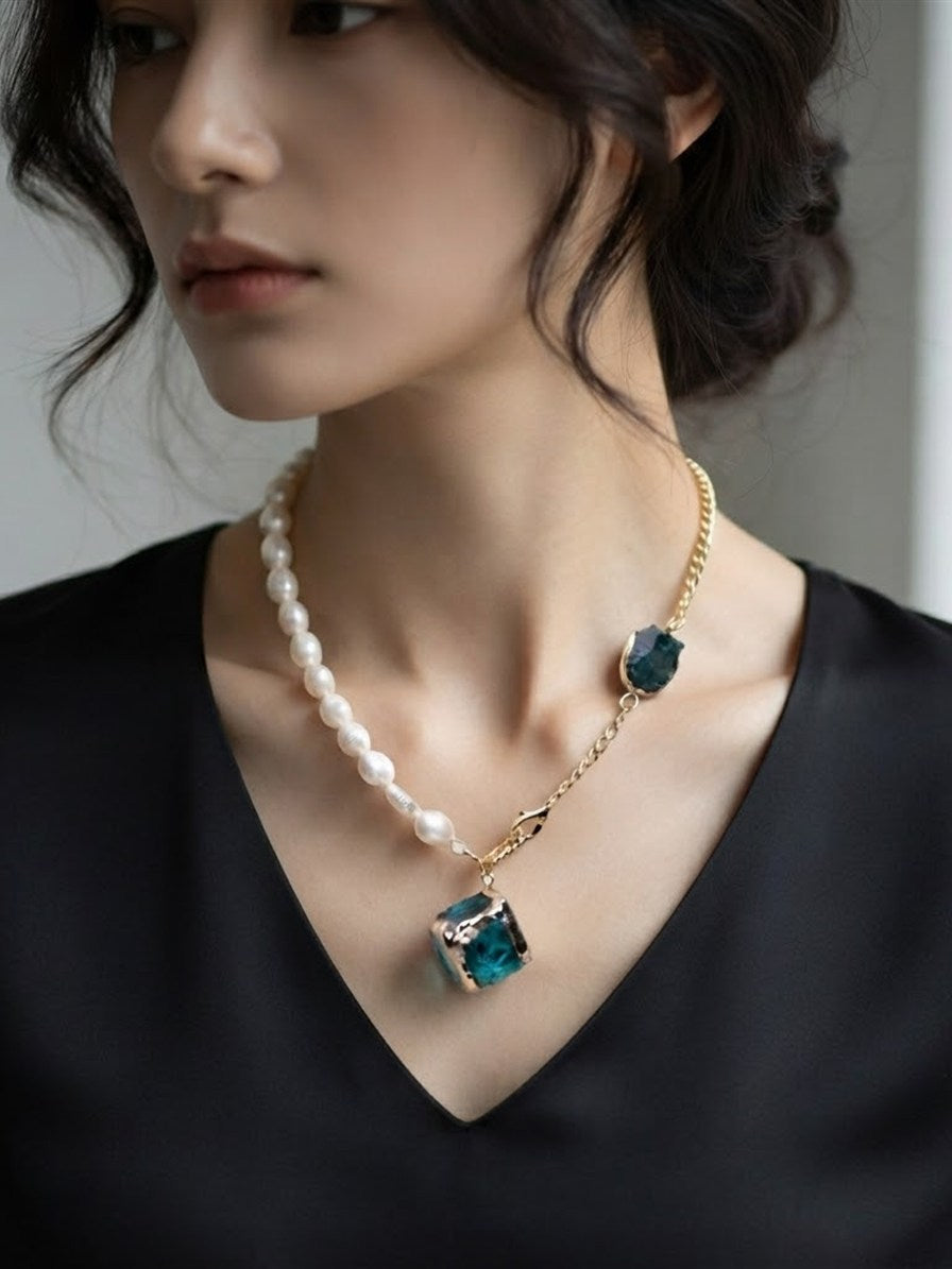 Freshwater pearl and teal raw stone statement necklace worn with a black top