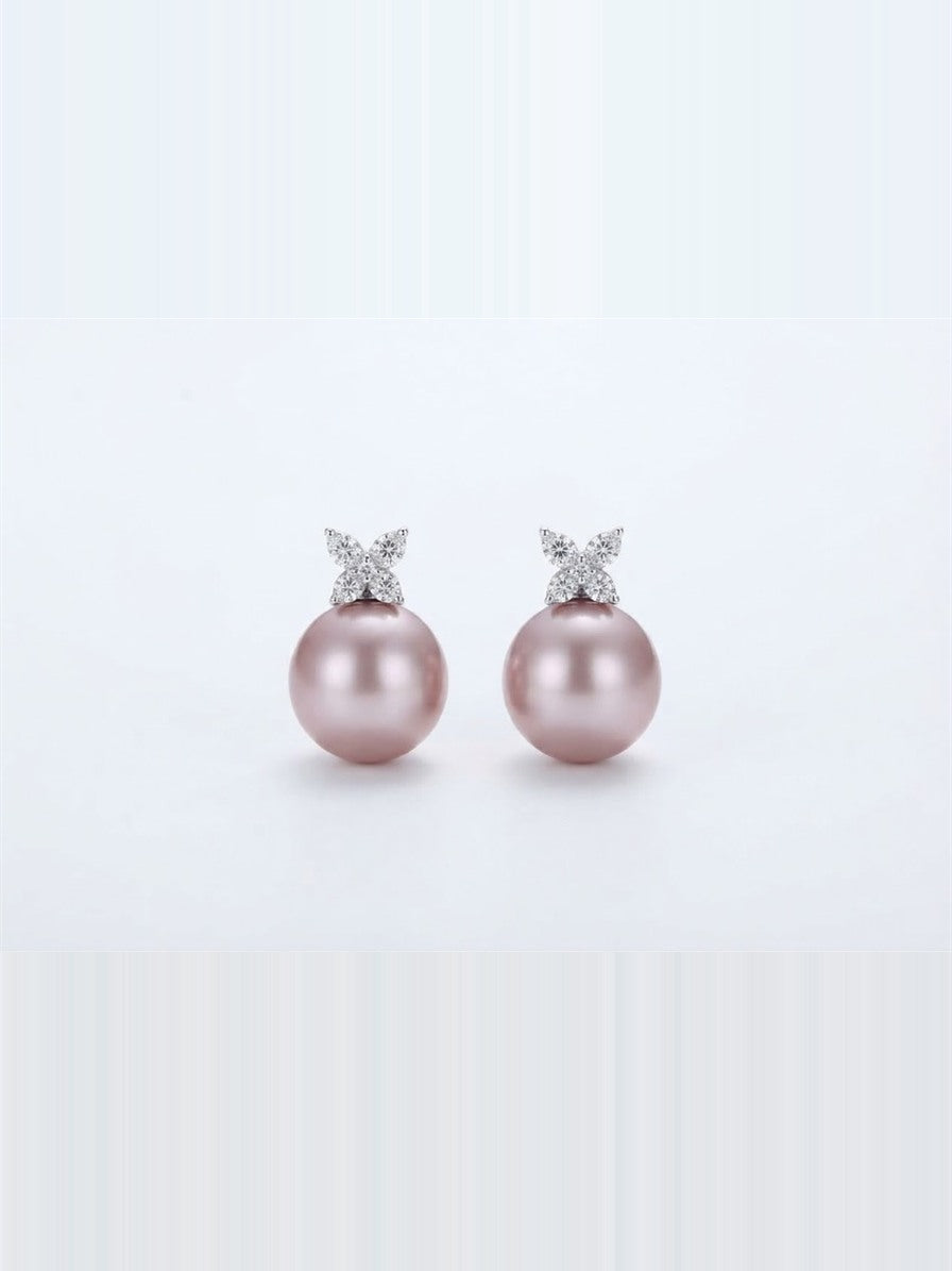 Pink pearl butterfly stud earrings in 925 silver on a white background