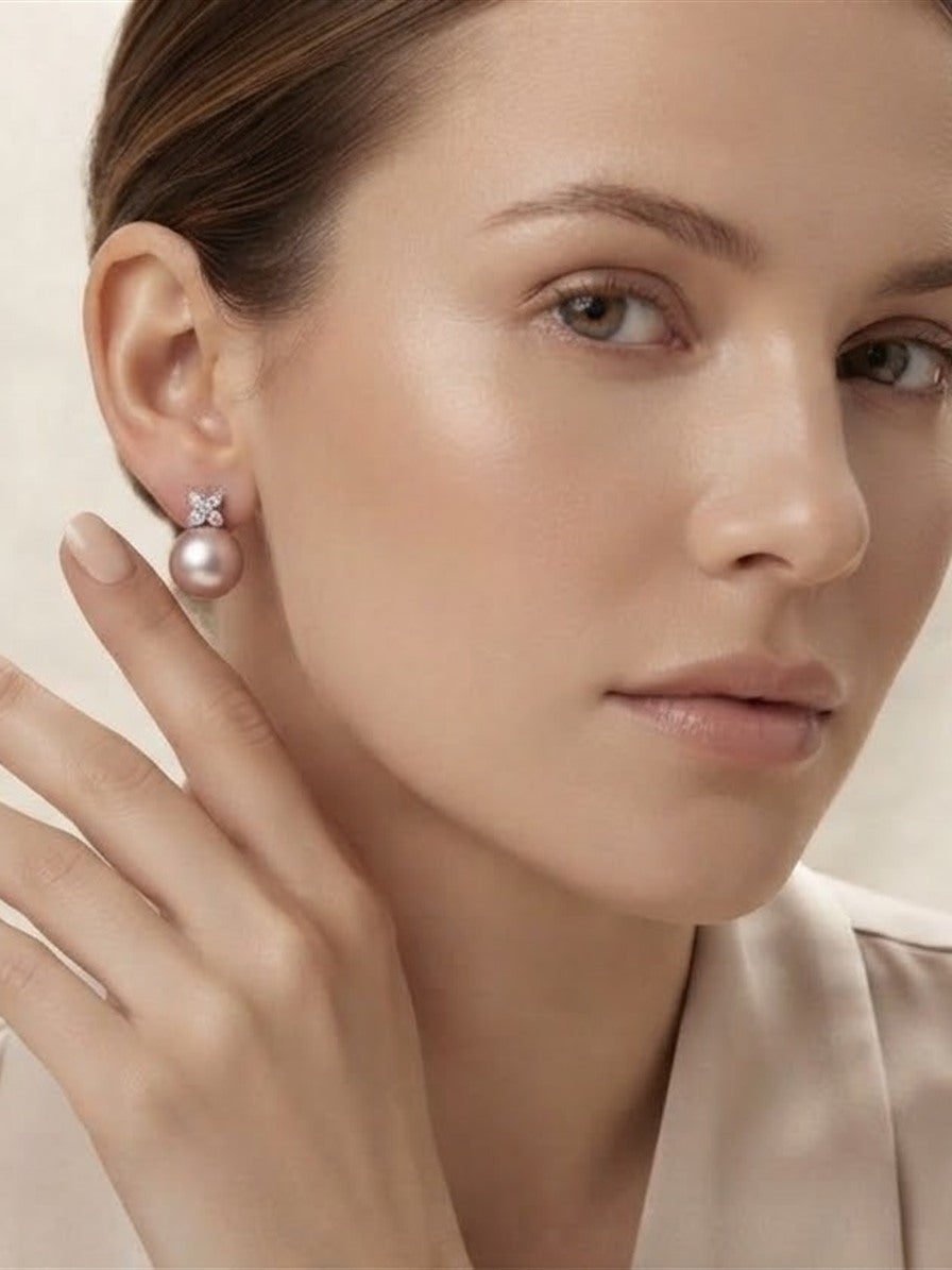 Model wearing a pink pearl butterfly stud earring