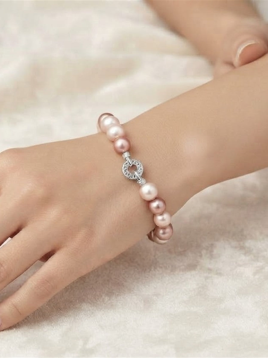 Pink freshwater pearl bracelet worn on the wrist