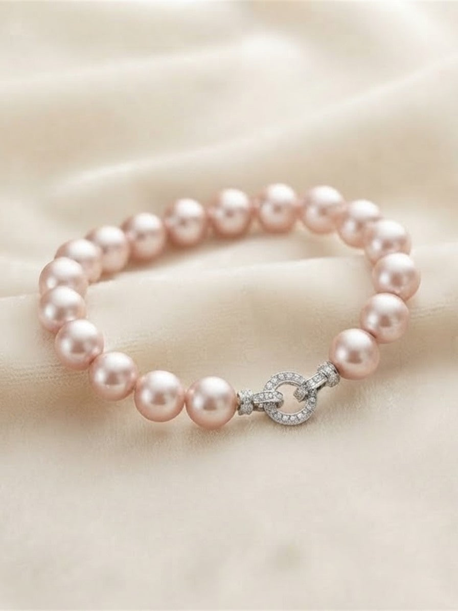 Pink freshwater pearl bracelet displayed on silk