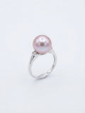 Lavender pearl ring with sparkling accent stones on a white background
