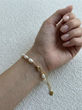 Freshwater rice pearl bracelet in gold-tone stainless steel worn on the wrist