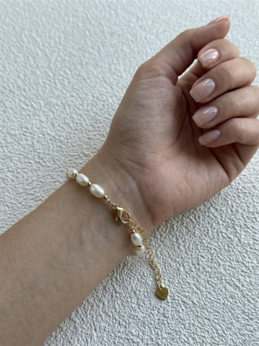 Freshwater rice pearl bracelet in gold-tone stainless steel worn on the wrist