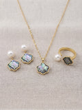 Freshwater pearl iridescent wave set: earrings, pendant necklace and ring on linen