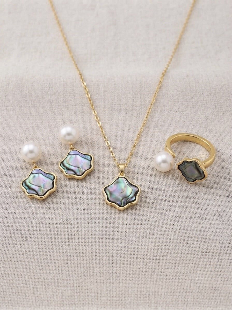 Freshwater pearl iridescent wave set: earrings, pendant necklace and ring on linen