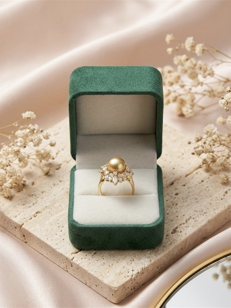 Golden South Sea pearl cluster ring in its gift box on travertine
