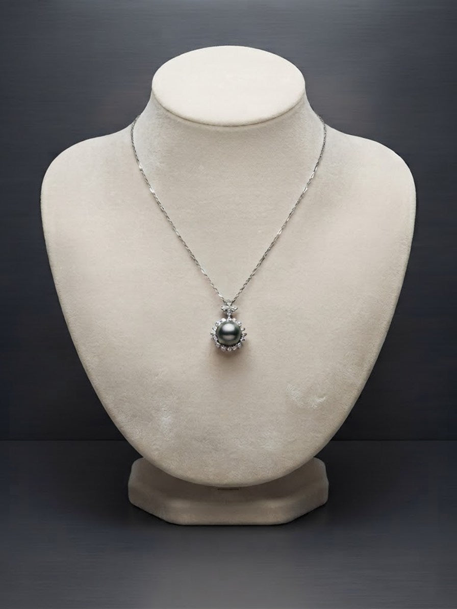 Tahitian pearl halo pendant on a velvet display bust