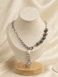 Tahitian pearl and heart charm chain necklace on a display bust