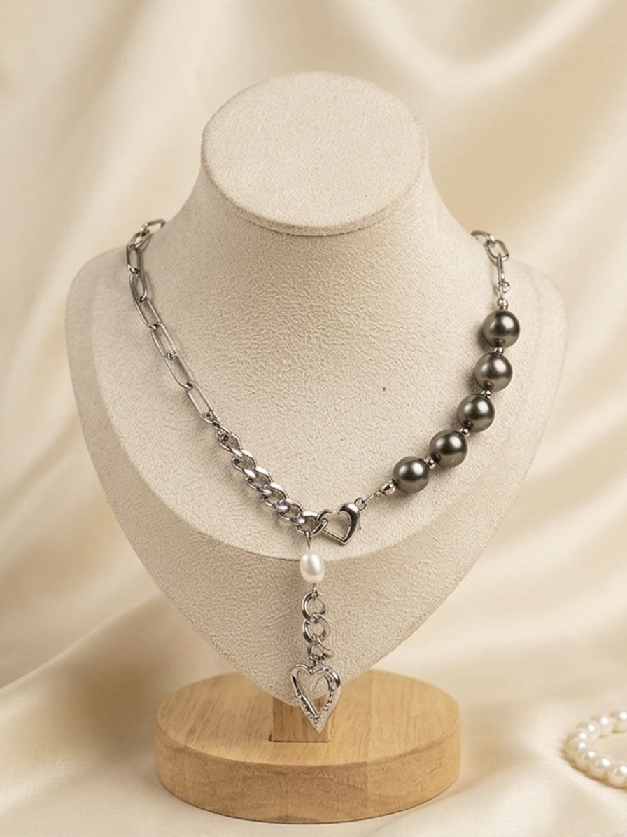 Tahitian pearl and heart charm chain necklace on a display bust