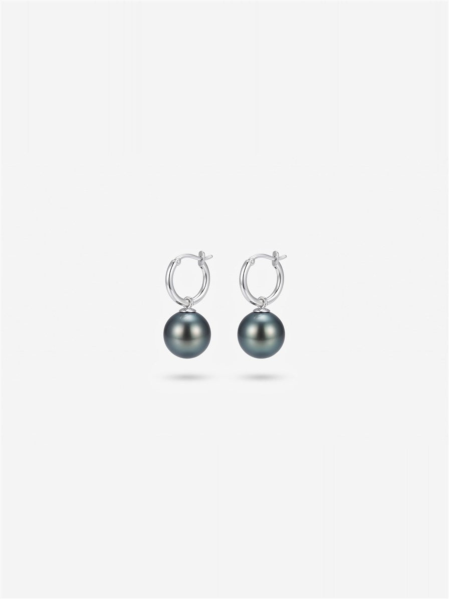 Tahitian pearl drop earrings on silver huggie hoops, white background