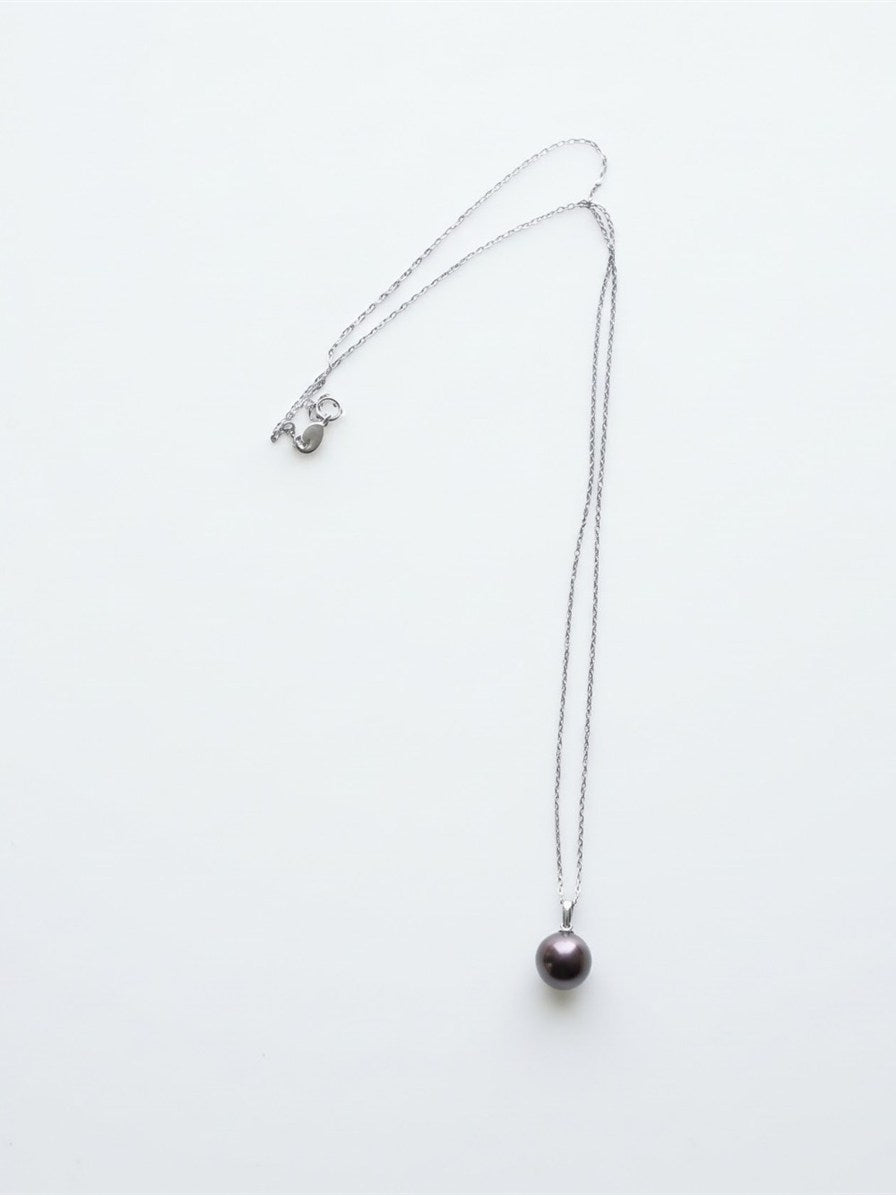 Chocolate Tahitian pearl pendant on a silver chain, white background