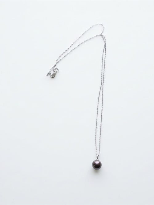 Chocolate Tahitian pearl pendant on a silver chain, white background