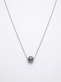 Single Tahitian pearl on a fine 925 sterling silver chain, close-up