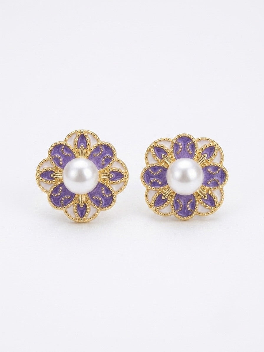 Gold-tone flower stud earrings with violet enamel petals and freshwater pearl centres