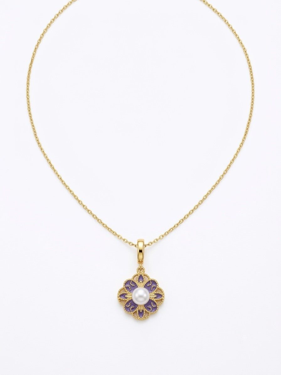 Violet enamel flower pendant with a freshwater pearl on a gold-tone chain