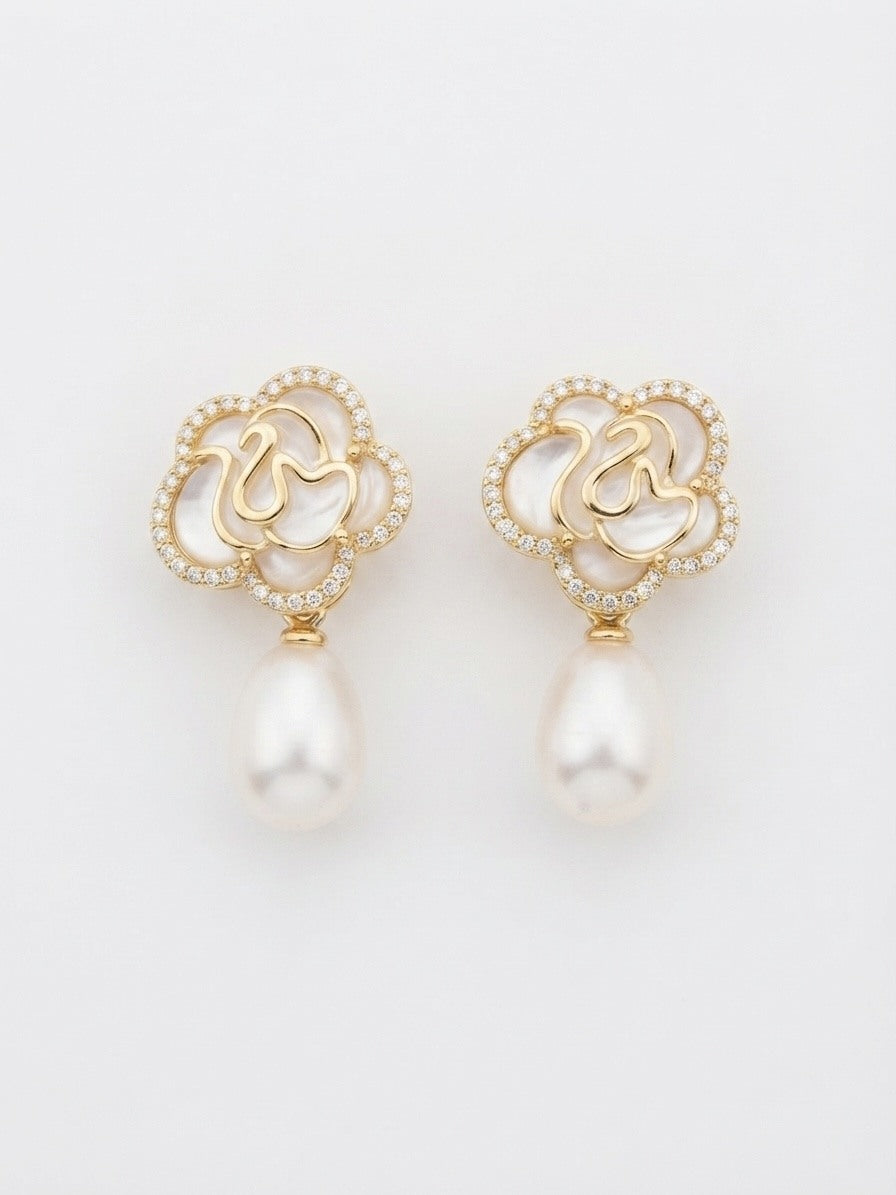 White flower earrings with freshwater pearl drops, close-up