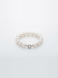 White freshwater pearl bracelet with sparkling round clasp on white background