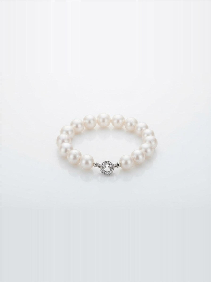 White freshwater pearl bracelet with sparkling round clasp on white background