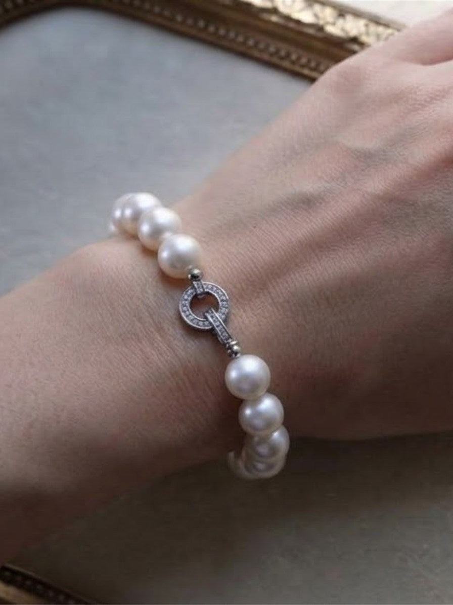 White freshwater pearl bracelet worn on the wrist