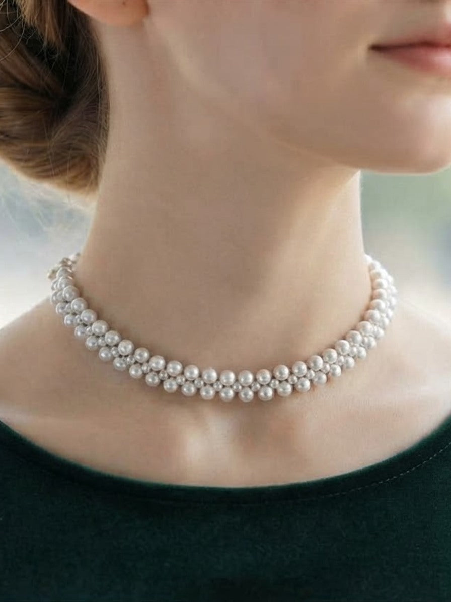 Woven freshwater pearl choker worn at the neck