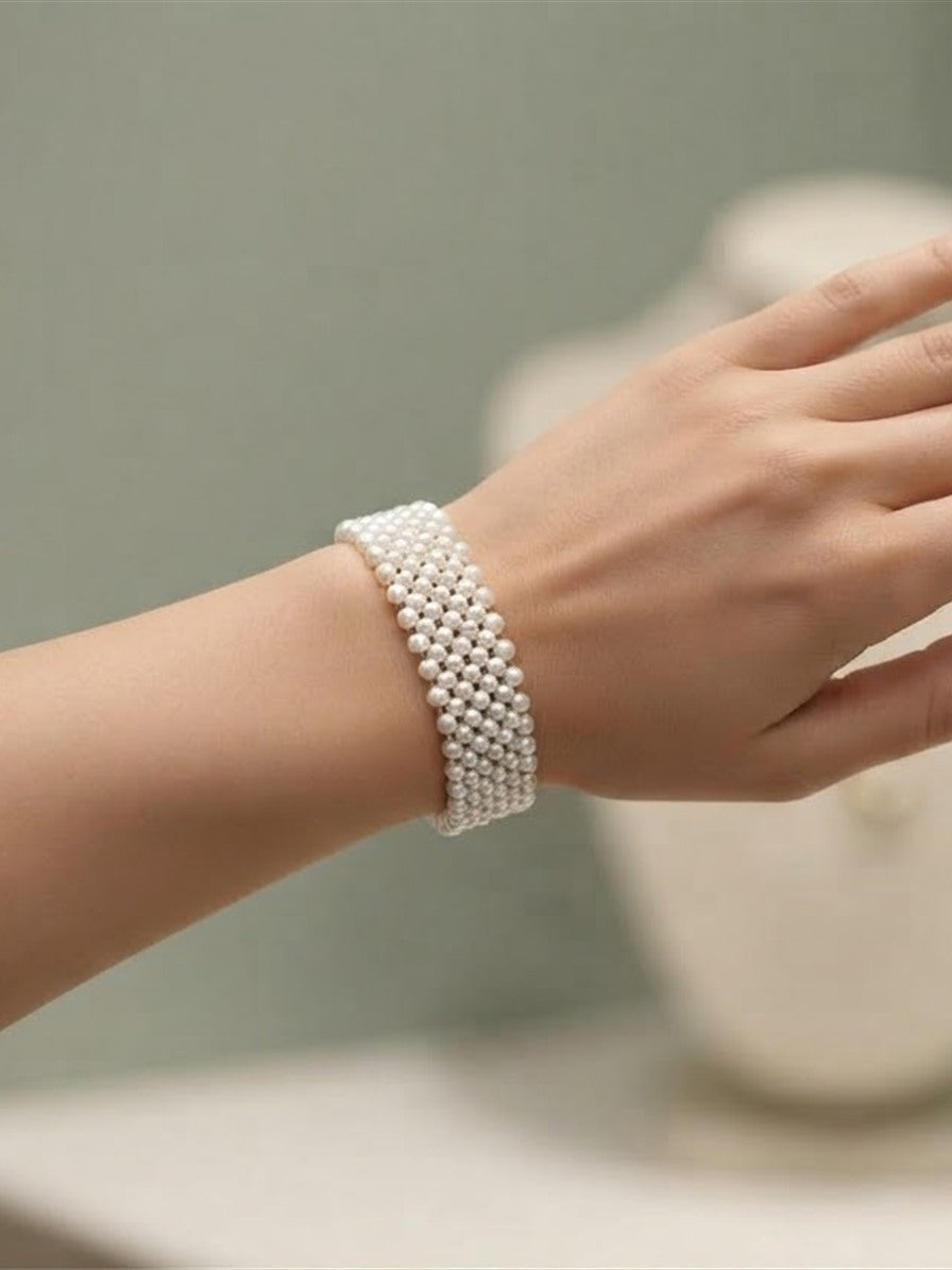 Woven freshwater pearl bracelet worn on the wrist